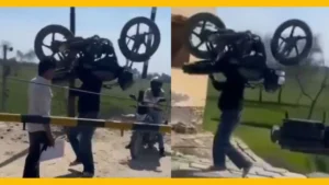 Man Hoists Bike Over Railway Barrier