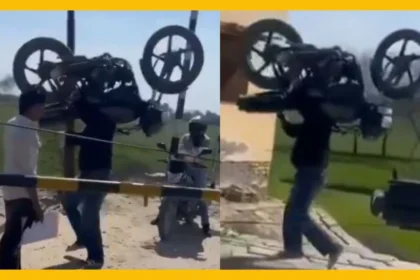 Man Hoists Bike Over Railway Barrier